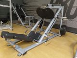 a gym equipment set up on a wooden floor in a gym
