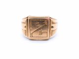 a close up of a gold signet ring on a white background