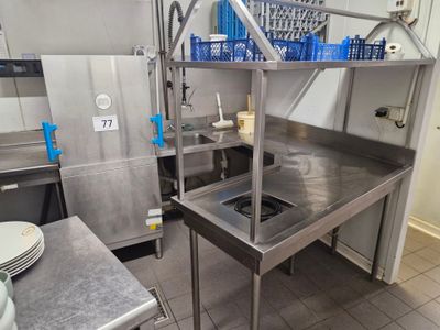 a large stainless steel kitchen with a sink and a stove