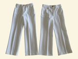 pair of white pants with buttons on the side of them