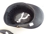 a black hat that is sitting on top of a pair of shoes