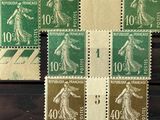 several different stamps of different colors and sizes on a black surface
