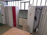 many lockers in a room with a red door