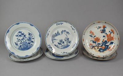 three blue and white plates with flowers and birds on them