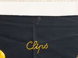 a close up of a black skirt with yellow flowers on it