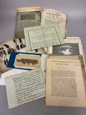 several old papers are piled on top of each other on a table