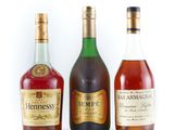 three bottles of different types of alcohol sitting next to each other