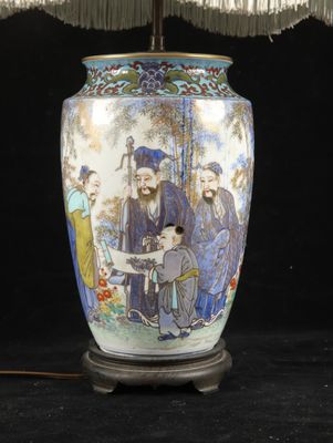 a lamp that has a picture of a group of people on it