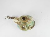 a picture of a frog keychain on a white surface
