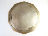 a silver plate with a gold rim on a white table