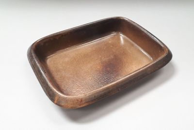 a brown tray that is sitting on a white table