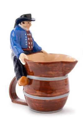 a figurine of a man sitting on top of a barrel