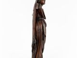 a wooden statue of a woman with a veil on her head