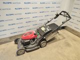 an image of a lawn mower parked in a garage