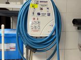 a blue hose attached to a wall in a kitchen