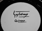 a picture of a black and white plate with a writing on it