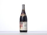 a bottle of wine sitting on top of a white table