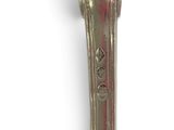 a silver spoon with a handle on a white surface