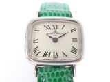 an image of a close up of a wrist watch with roman numerals on it