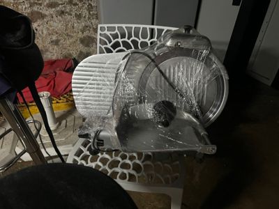 a plastic chair that has been wrapped in plastic and is next to a metal chair