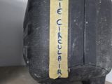 a black suitcase with a yellow stripe on it sitting on a shelf