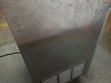 an image of a stainless steel refrigerator in a warehouse