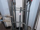 a small hand truck that is sitting next to a pile of boxes