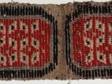 an image of a red and black rug hanging on a wall