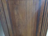 an image of a wooden cabinet in a bathroom
