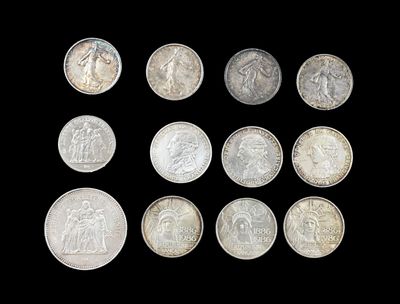 six different types of silver coins on a black background