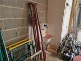 a bathroom with a toilet and a ladder in the corner
