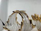 pair of gold and clear glass vases sitting on a white surface