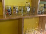 many glasses on the shelves in the room