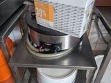 a metal table with a basket on top of it in a kitchen