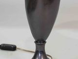 a lamp that is sitting on a table with a remote