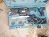a blue tool box with tools in it on the floor