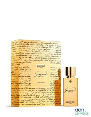 a bottle of perfume sitting next to a box with writing on it