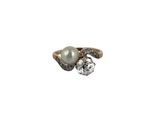an image of a pearl and diamond ring on a white background