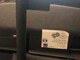 a suitcase with a tag on it sitting on the floor