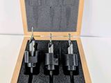 a set of four drill bit set in a wooden case