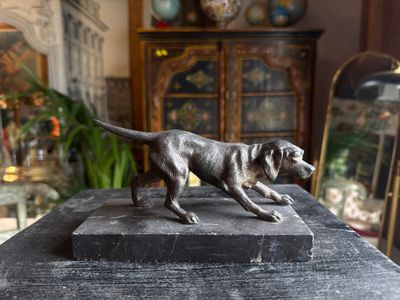 a statue of a dog on a table in a living room