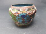 a vase with a colorful design on it on a table