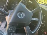 a steering wheel and dashboard of a vehicle in the sun