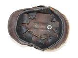 a brown leather hat with a smiley face on it