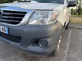 a grey toyota hilux parked in a parking lot