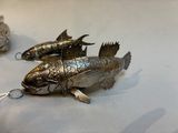 two fish that are sitting on a table together