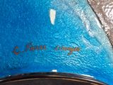 a close up of a blue surfboard on the ground