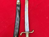 two knives are sitting on a red cloth on a table