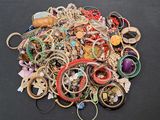 a pile of assorted jewelry on a black surface