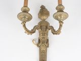 pair of antique brass wall sconces on a white background